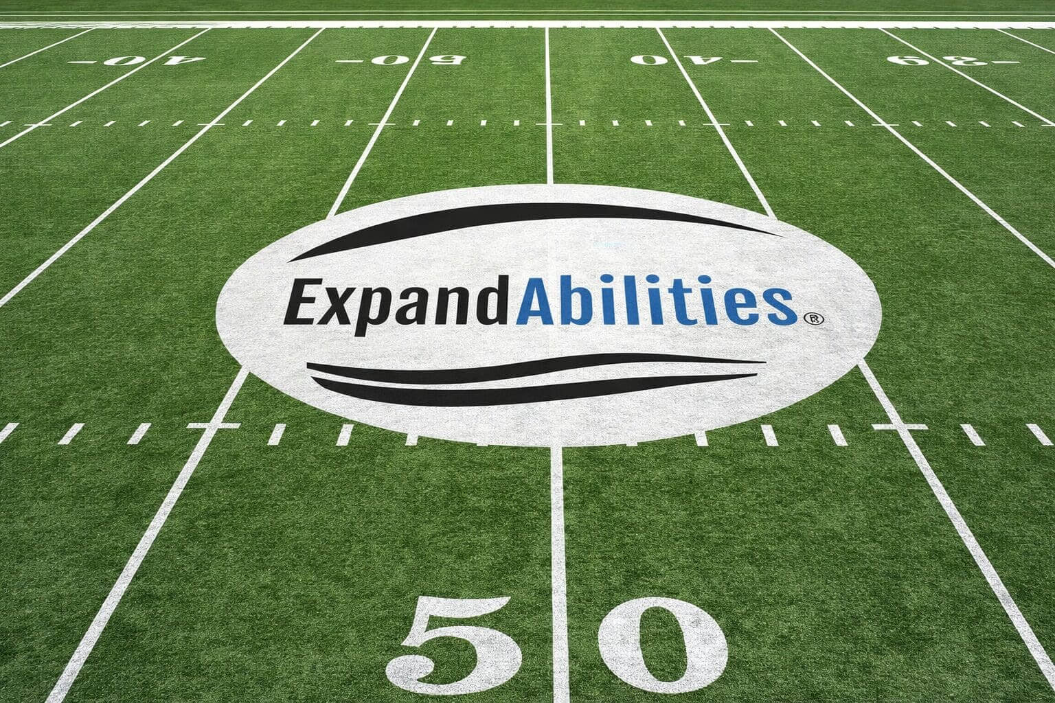 Football field with ExpandAbilities logo at center.